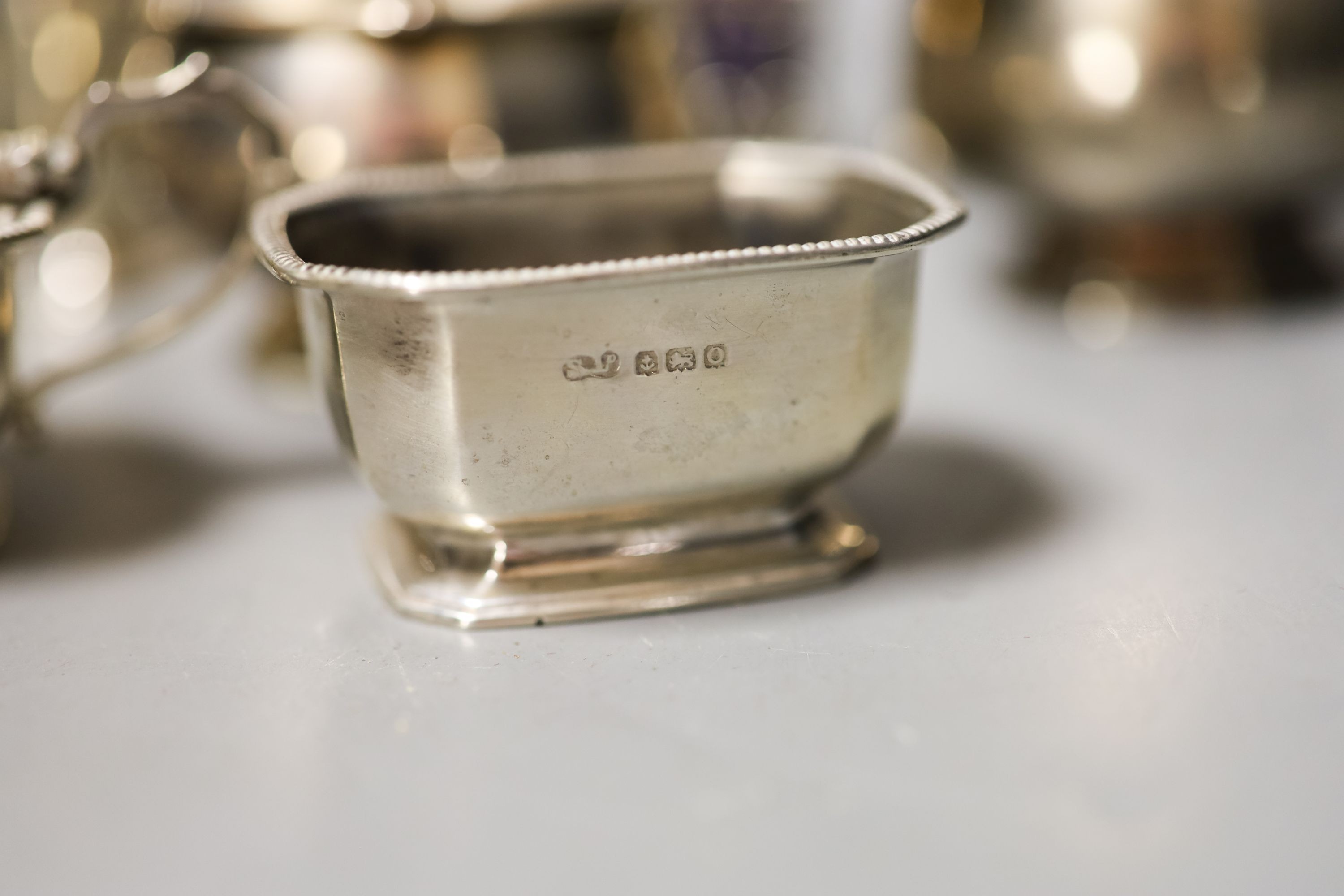 Twelve assorted 20th century silver condiments including an Art Deco three piece set, Birmingham, 1939.